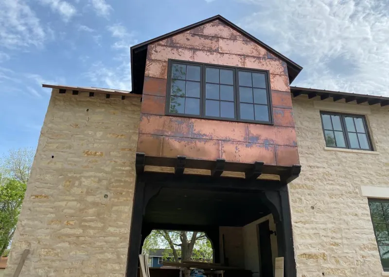 Copper metal panel facade on a stone building for Skylight Installation in Warner Robins