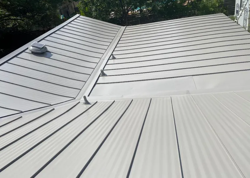 Solar attic fan installed on a metal roof for Roof Ventilation in Warner Robins